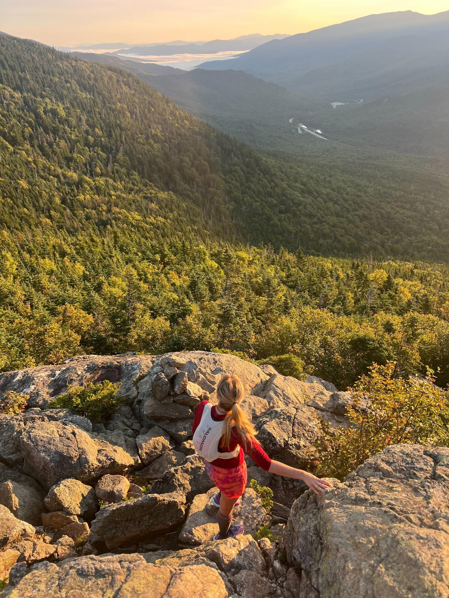 A trail runner looking out into the mountains.